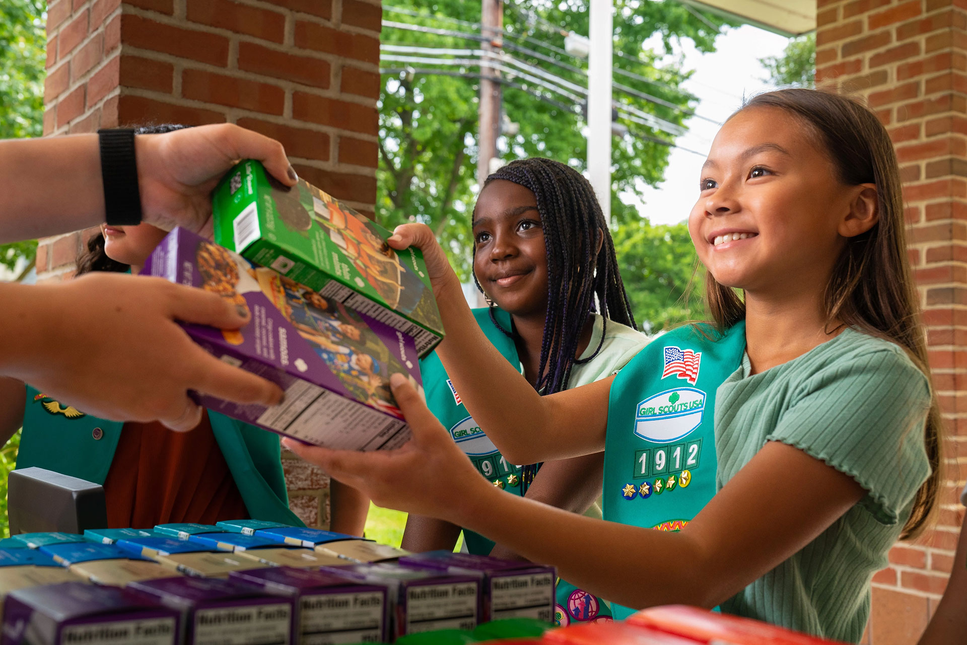 Two young girl scouts selling cookies