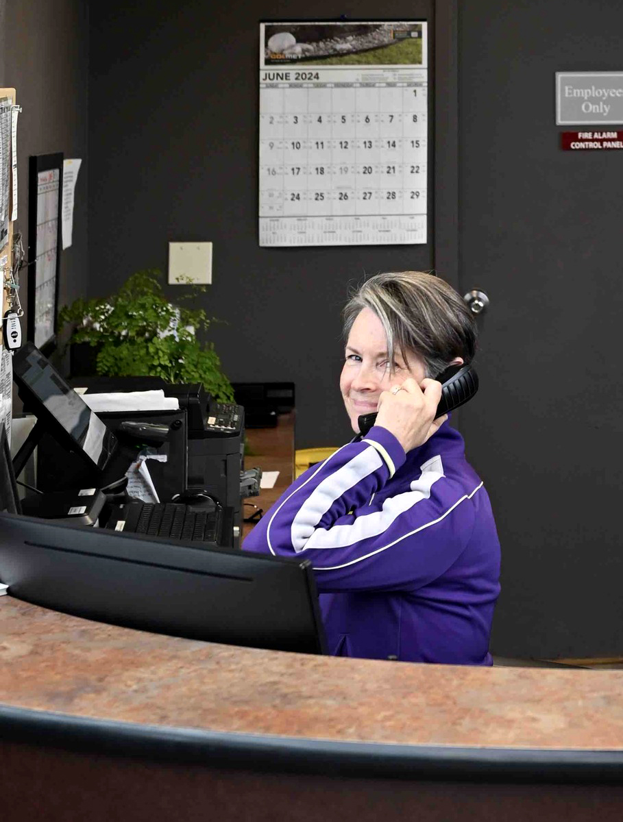 Woman answering the phone at a desk at Al's Garden and Home Store.