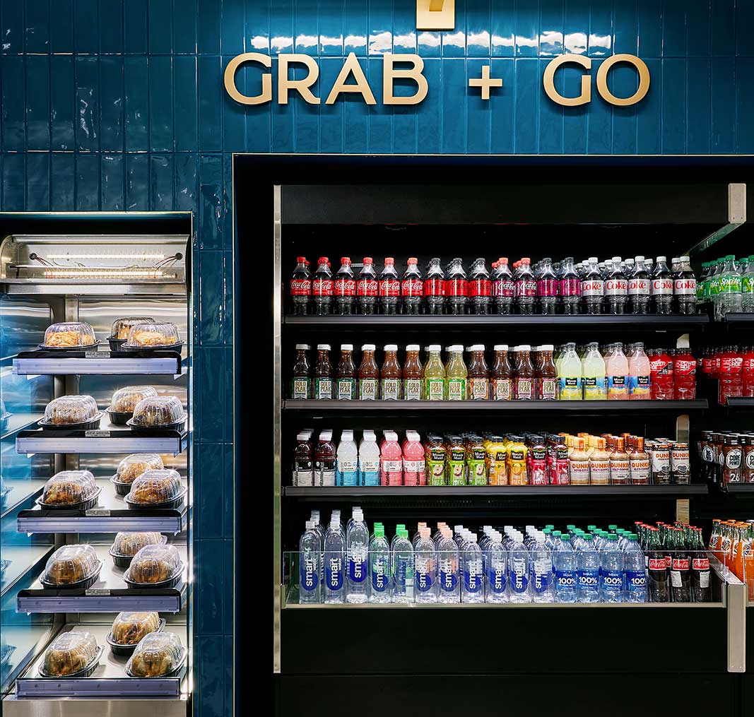 Nemacolin Grab + Go section of the grocery store with beverages on shelves.