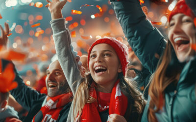 Fans cheering for their sports team while watching a game from stadium stands.