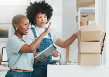 Two retail business women going over inventory and training.