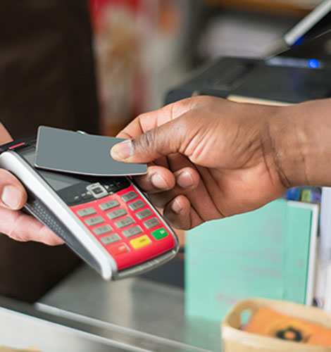 Person using a loyalty card to pay for their purchase.