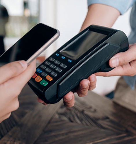 Retail customer using their mobile phone to pay for their purchase.