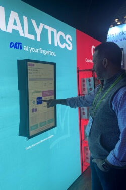 Kevin Albert looking point of sale analytics on a touch screen.