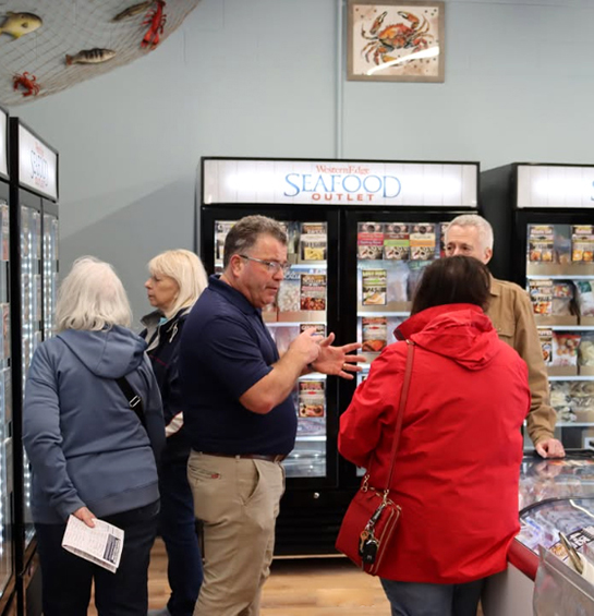 Customers inside Western Edge Seafood Outlet retail store.